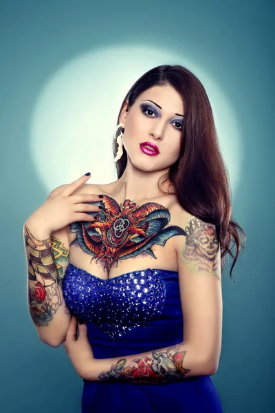 Pretty tattooed girl in dark blue dress