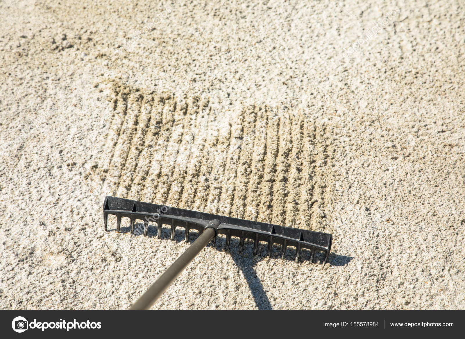 Sand rake in a golf trap, raking the sand Stock Photo by ©lillitve 155578984
