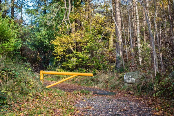 Yellow gate barrier prevents cars driving on the footpath