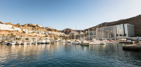 Puerto Rico, Gran Canaria - December 12 2017: Marina of Puerto Rico, a very popular travel destination. Sailboats in the harbor. Hotels in the background. — Stock Photo, Image