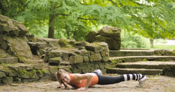 Chica joven haciendo ejercicio en el parque . — Vídeos de Stock