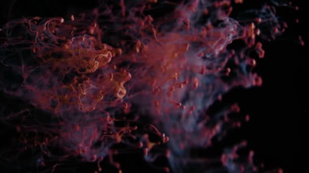 Particules rouges abstraites sur fond noir, Encre rouge dans l'eau 