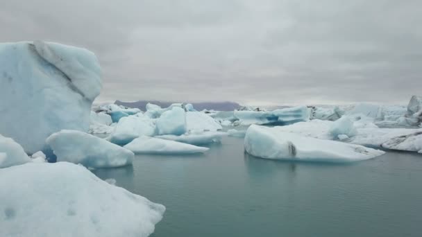 Aérea sobre icebergs flotando en la laguna de Jokulsarlon cerca de la costa sur de Islandia — Vídeo de stock