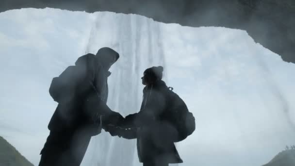 Man and woman looking at waterfall — Stock Video