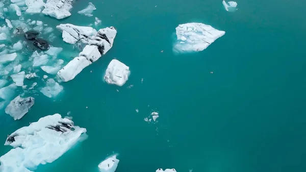 Aerial over icebergs floating in Jokulsarlon Lagoon by the southern coast of Iceland