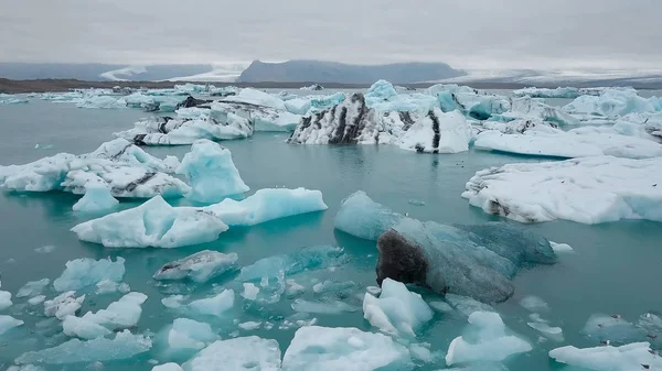 Aerial over icebergs floating in Jokulsarlon Lagoon by the southern coast of Iceland