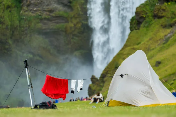 Telttailu telttoja lähellä kuuluisaa Skogafoss vesiputous Skoga joella. Islanti kuvapankkikuva