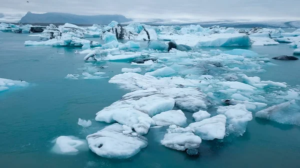 Aerial over icebergs floating in Jokulsarlon Lagoon by the southern coast of Iceland