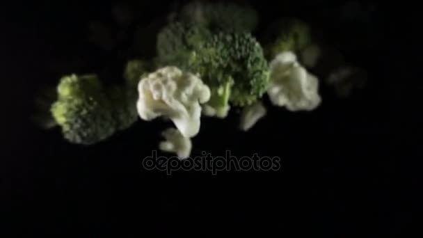 Cauliflower falls in the air on a black background. slow motion. — Stock Video