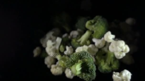 Cauliflower falls in the air on a black background. slow motion. — Stock Video