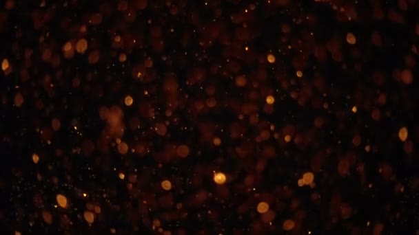 Abstrakte goldene Bokeh-Teilchen. Hintergrund mit leuchtenden Bokeh-Funkeln. glatte Animationsschleife. mit zentraler Stelle für Ihren Logotext. — Stockvideo