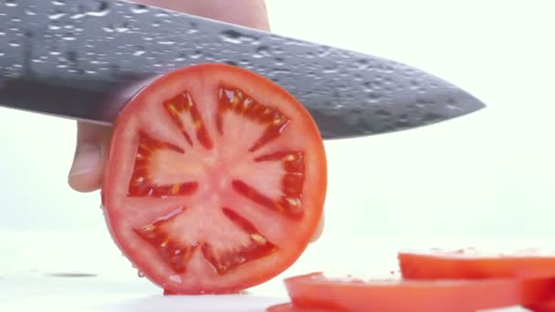 A Stäng att skära en tomat med en kniv. — Stockvideo