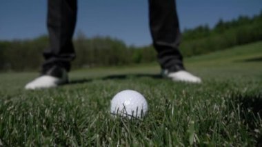 Golf Kulübü ağır çekimde yeşil suni çim üzerinde topa vuruyor