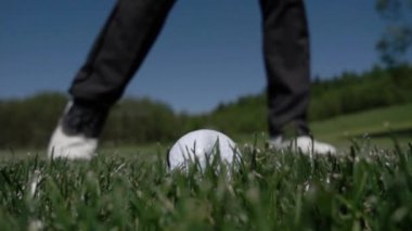 Golf Kulübü ağır çekimde yeşil suni çim üzerinde topa vuruyor