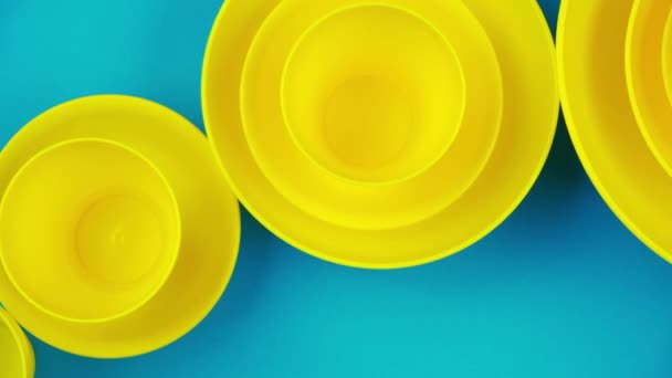 Flat lay yellow cups on a turquoise background. Harsh pastel colors. Minimalistic design style. — Stock Video