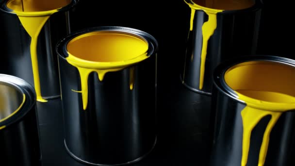 Colorful paint leaking down on wall of metal bucket. Isolated over black background. shot on slider — Stock Video