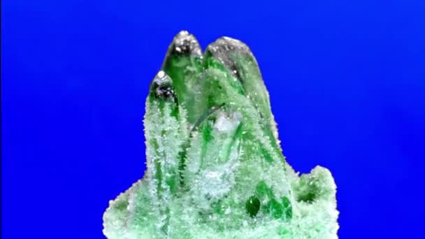 Esmeralda crua e pedra preciosa cristal de rocha áspera no fundo azul — Vídeo de Stock