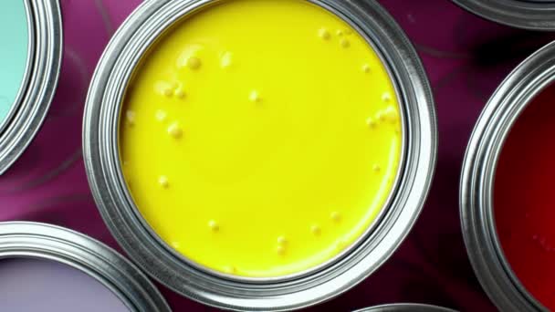 Colorful paint of a metal bucket. top view Pink background — Stock Video