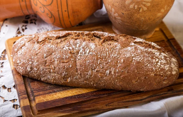 Whole wheat bread on a wooden blackboard — Stock Photo, Image