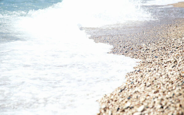 Wave Of Blue Sea On pebble Beach
