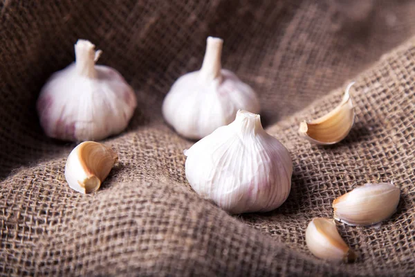  Sarımsak ampuller ve çul arka plan üzerinde diş sarımsak
