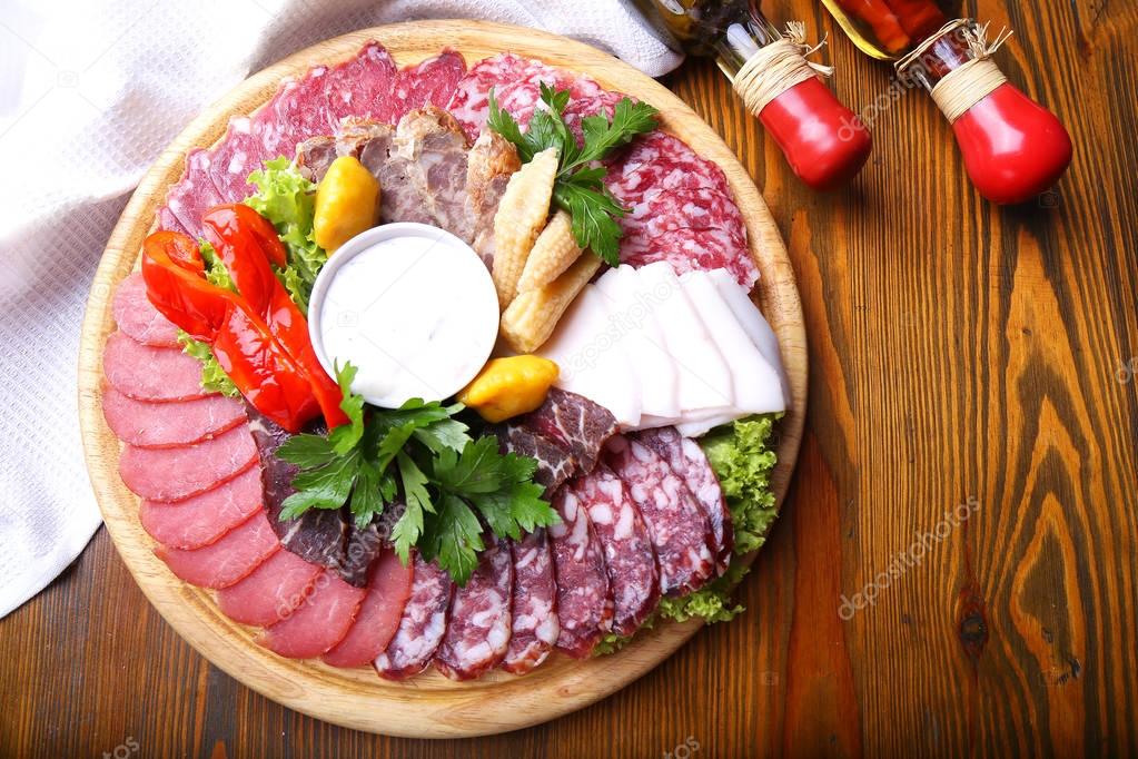 Tasty Cold meat on wooden board. Top view