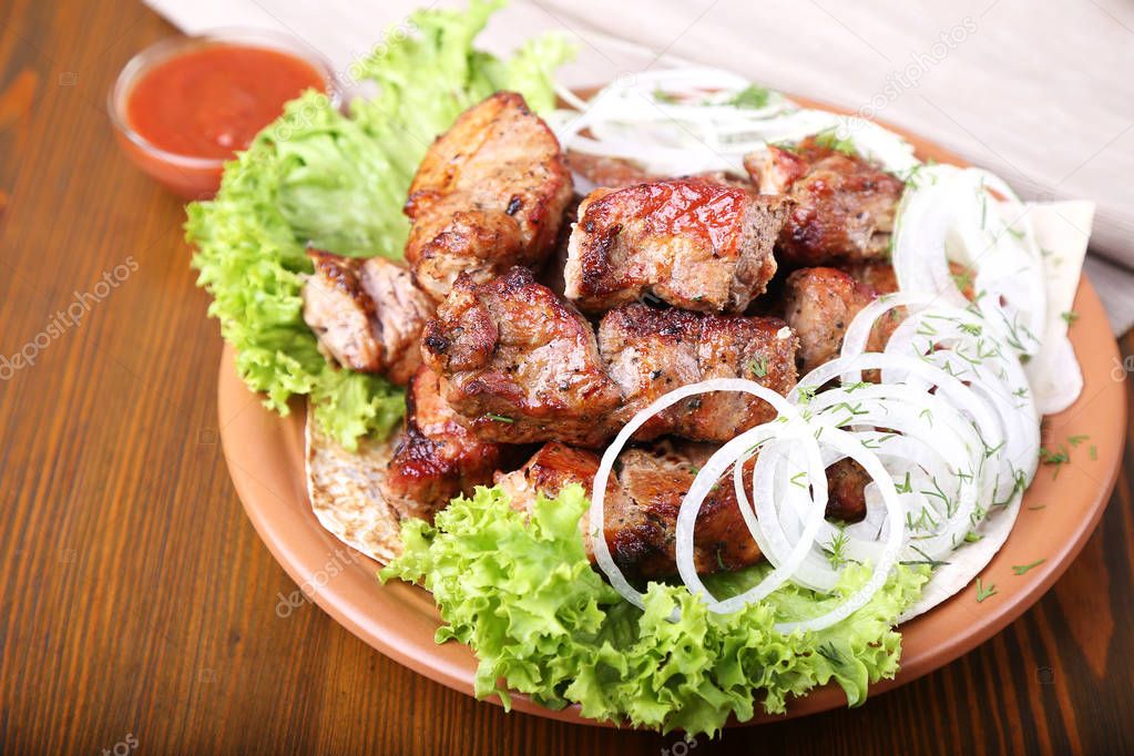 Pieces of meat with onions on skewers kebab . 