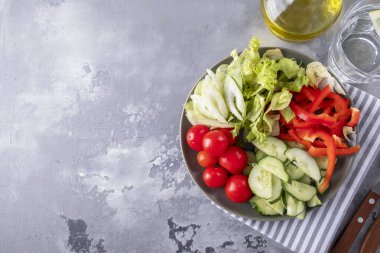 Tabakta taze sebzeler. Kırmızı biber, salatalık, kereviz, kiraz ve marul. Uzayı kopyala Üst görünüm
