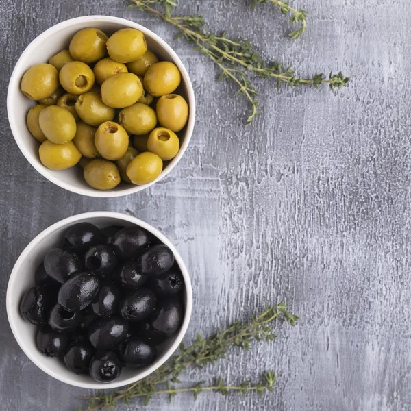Black and Green olives  in a bowl. Top view