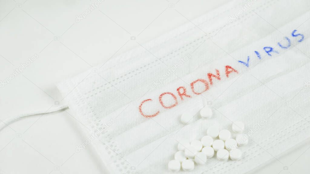 Pandemic. White medicine masj with white pills. Stop coronavirus