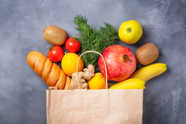 Paper bag with vegetables and fruits. Different food in paper bag. Top view