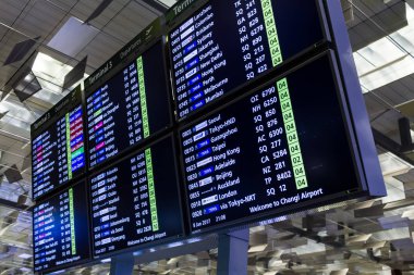 SINGAPORE - JAN 8, 2017: Visitors walk around Departure Hall in Changi International Airport  clipart