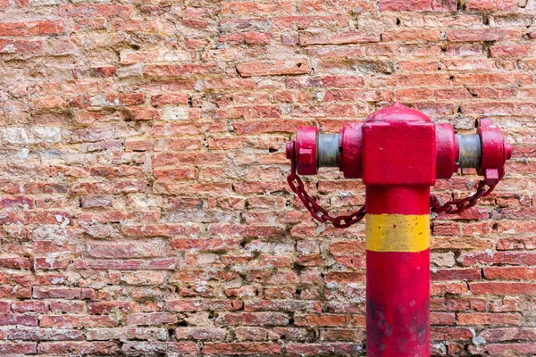 Fire Hydrant at the Dirty Brick Wall