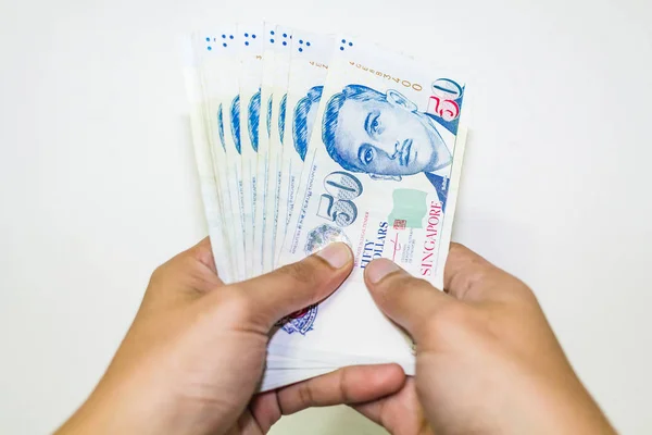 Singapore Currency with Hand Isolated in white background — Stock Photo, Image