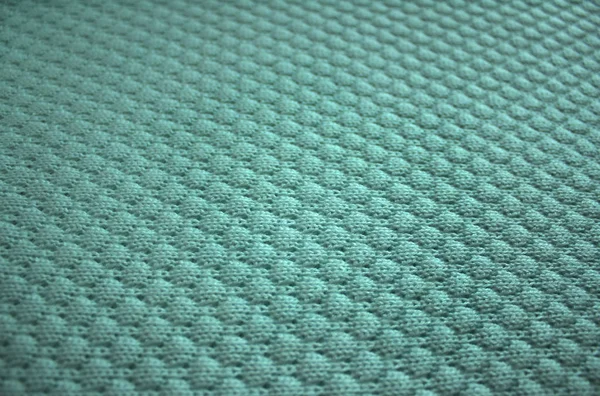 Knit texture of blue wool knitted fabric with pattern.