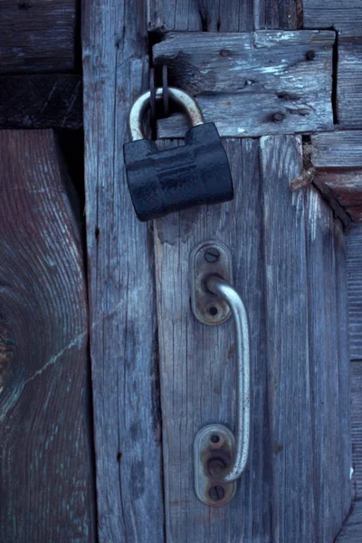 Iron lock on an old wooden door.