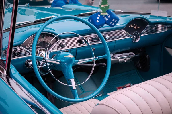 TORONTO, CANADA - 08 18 2018: Steering wheel with logo on horn button, dials and knobs on front panel of 1956 Chevrolet Bel Air oldtimer car on display at auto show Wheels on the Danforth — Stock Photo, Image