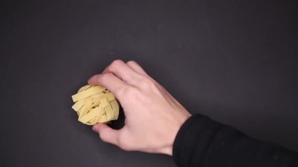 Top view of tagliatelle served in balls on a black background — ストック動画