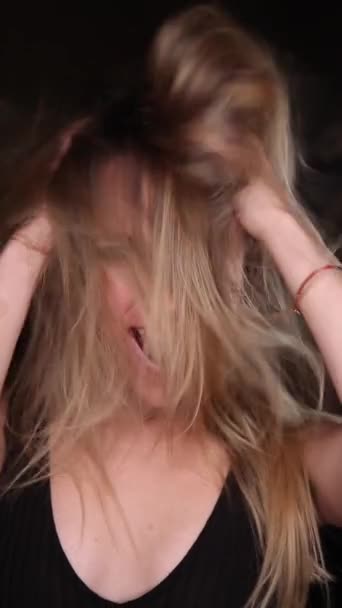 A beautiful girl with green eyes has fun, shows joy, shakes her hair. Vertical video. Instagram video — Stock Video