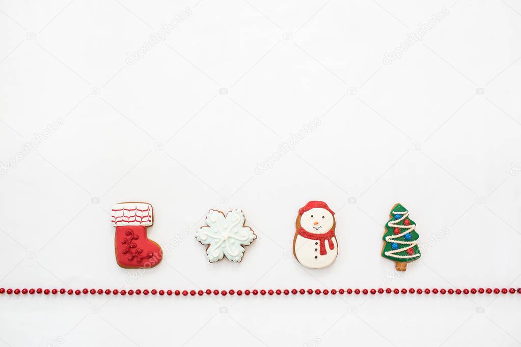 Gingerbread cookies hanging over white background