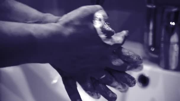 Facet myje ręce mydłem w płynie w łazience. Pomysł na wirus korony. — Wideo stockowe