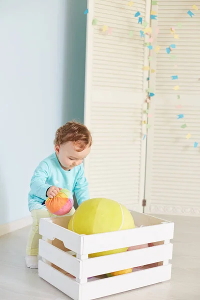 Little child is playing with toys in the studio — Stock Photo, Image