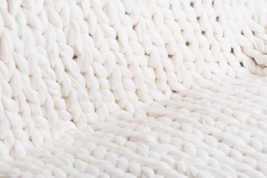 Kumaş kalın bej kazak yakın çekim doku. Örme doku arka plan