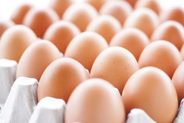 Eggs cooking for breakfast, a protein form yolk and albumen on a white background, or on a plain wooden table.