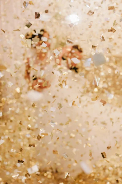 bride and groom dancing the first dance.Golden sparkles confetti. wedding dance