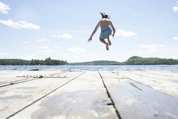 Pre Teen Boy Jumping Off Dock at Cottage — Stock Photo, Image