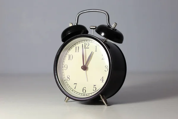 Black alarm clock. Cream dial — Stock Photo, Image