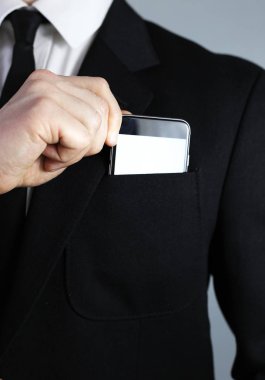 siyah elbiseli bir iş adamı. telefon koymak