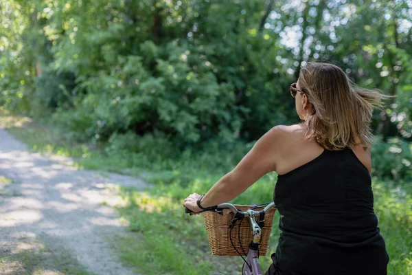 woman riding bike in casual clothing