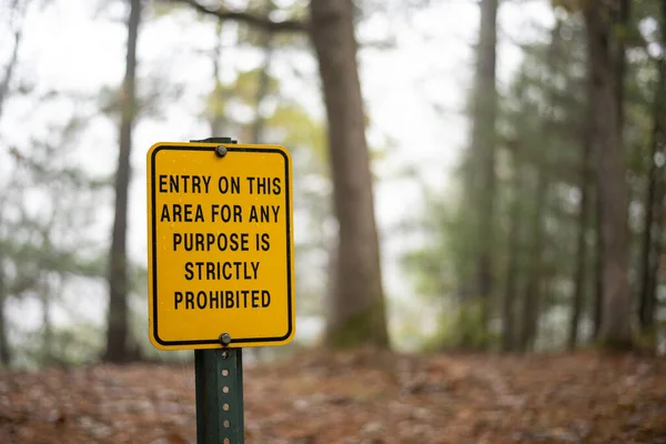 yellow sign on post in Wisconsin State Park Entry on this area for any purpose is strictly prohibited